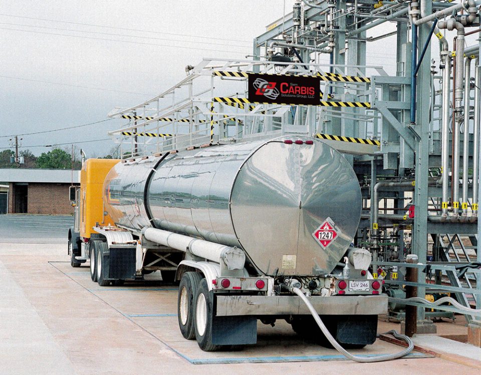 A truck enclosure sits atop the tank of a tanker truck.