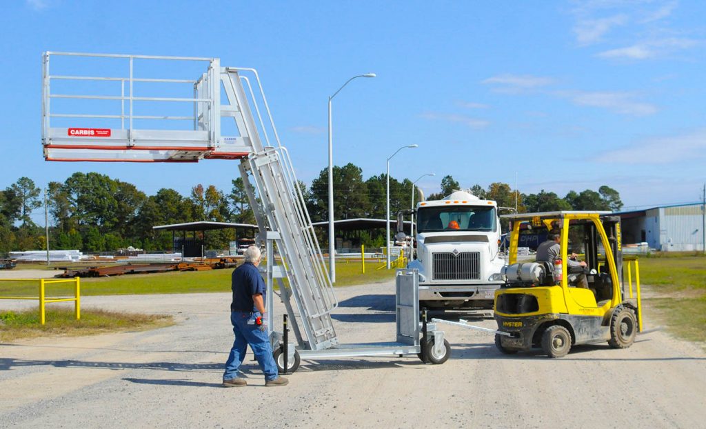A Carbis portable tanker truck access system is pulled by a forklift..