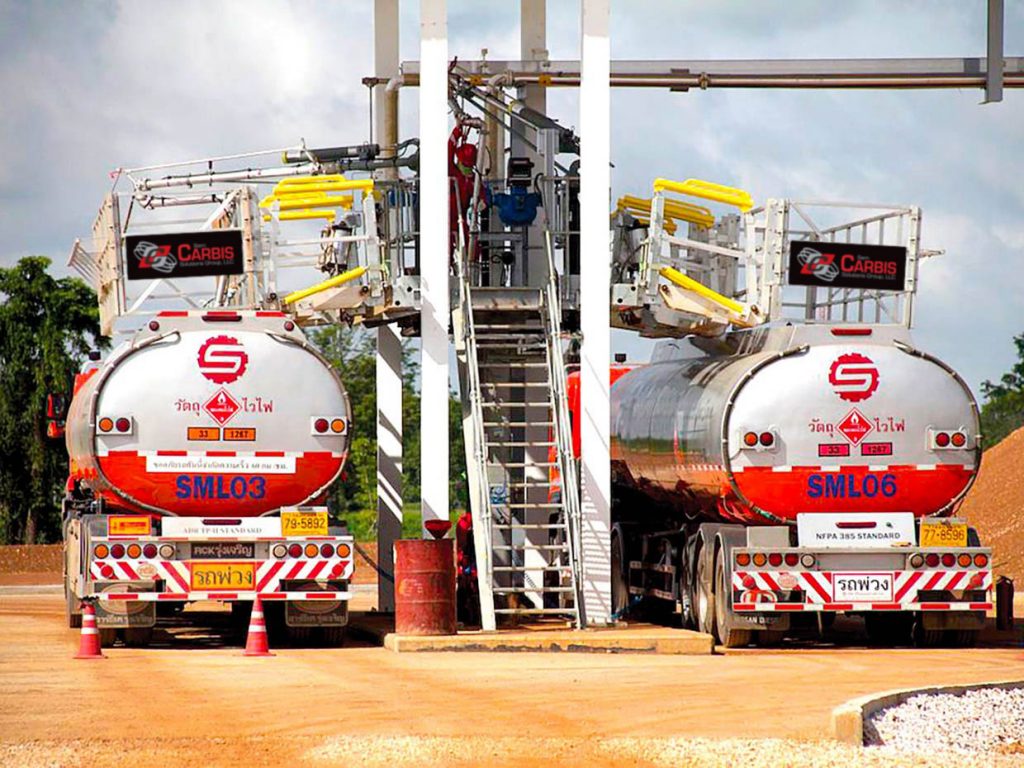 A truck enclosure dock/bay with two tanker trucks underneath.