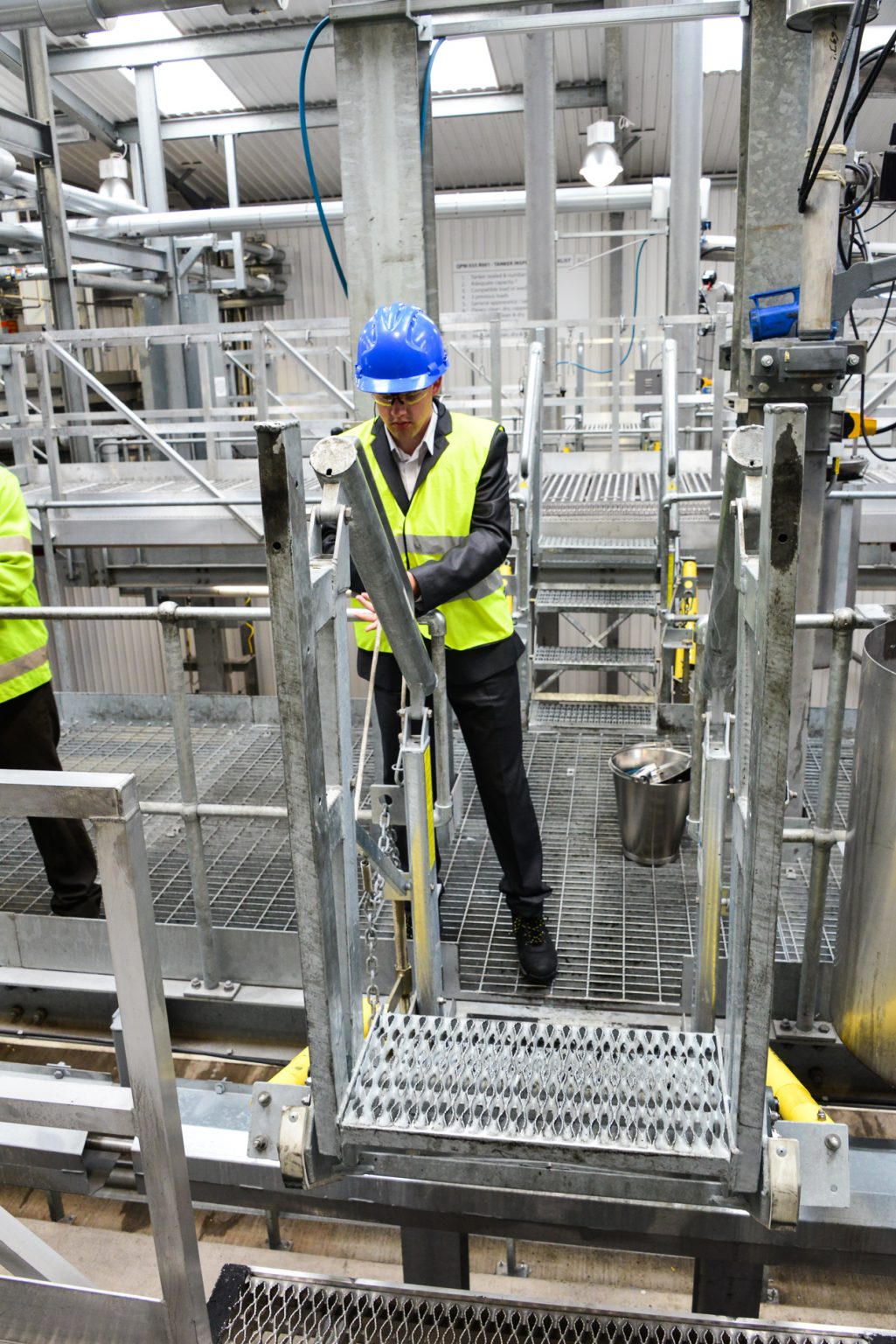 A worker is on top of a flat ramp in a unit.