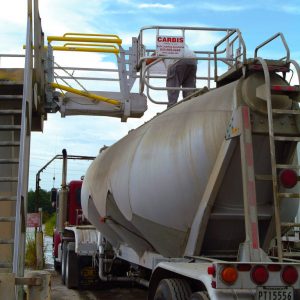 A worker on a gangway stands on top of a tanker truck.