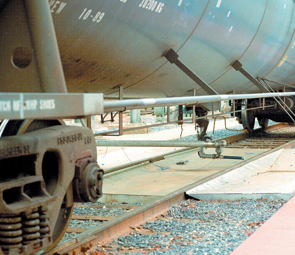 a loading arm pan is placed under a tank railcar to prevent spills.