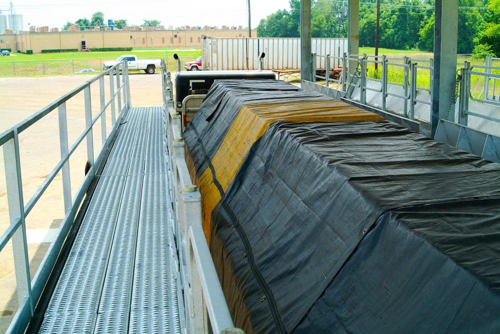 A flatbed load fully tarped at the tarping dock.